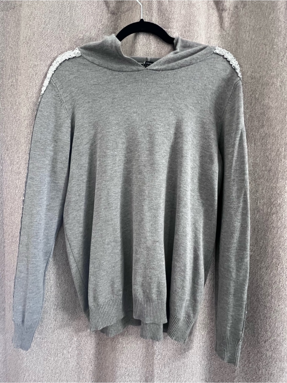 Grey hooded sweater with sequins on the sleeves